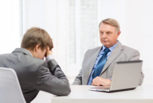 older man and young man having argument in office